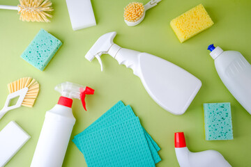 Cleaning supplies: bottles, sponges, brushes, and cloths for home hygiene.