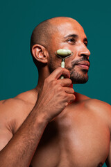 Beauty portrait of middle-aged hispanic black handsome man on colored background, concepts about beauty treatment, skincare and cosmetics for men