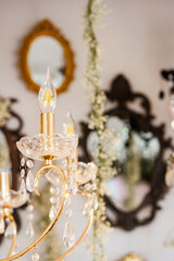 Elegant chandelier with decorative mirrors in stylish interior setting