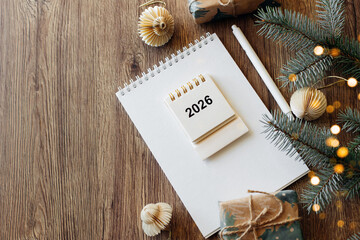 Festive Notepad with 2026 Calendar and Holiday Decorations on Wooden Table