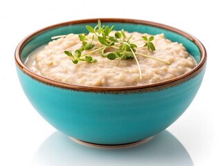 Delicious creamy oatmeal topped with fresh sprouts in a vibrant teal bowl white background
