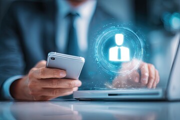 Businessman using laptop and phone, holographic profile icon overlay