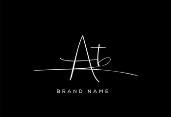 AT letter beauty cursive handwriting logo.
