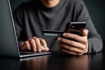 Close-up of person using laptop, phone, and credit card for online purchase