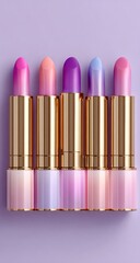 Gradient lip glosses in pastel shades, gold-toned packaging