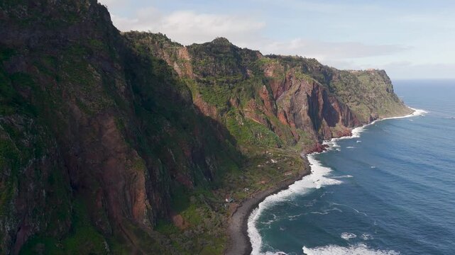 Aerial Drone Establishing Shot of Lush Green Cliffs and Coastline at Rocha do Navio Nature Reserve, Santana, Madeira, Portugal.