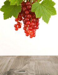 Fresh red currants on a wooden surface