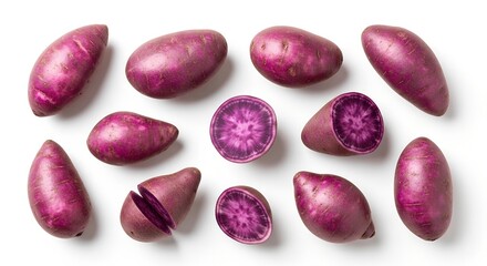 Top view of whole and halved purple potatoes with vibrant purple flesh scattered on a white background.