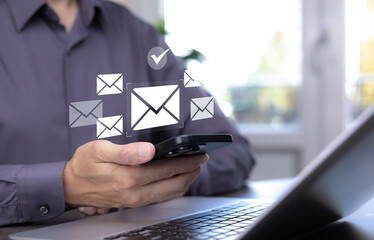 Businessman sending email by laptop computer to customer, business contact and communication, email icon, email marketing concept, send e-mail or newsletter, online working internet network.