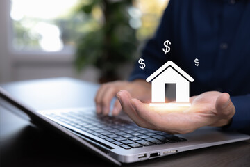 Businessman using laptop with virtual house and dollar icons. Real estate investment, property market, mortgage loan, housing finance, home ownership and financial technology concept.