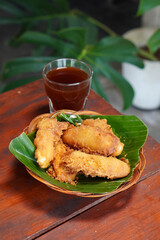 Indonesian Fried Banana, captured on September 2, 2025. Traditional snack of ripe banana coated in crispy golden batter, served on rustic plate, authentic homemade flavor