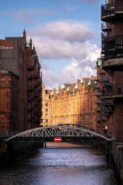 Speicherstadt warehouses with canal and iron bridge in Hamburg, Germany, historic industrial architecture and UNESCO World Heritage Site representing cultural identity and legacy