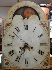 The moon dial of an antique grandfather clock