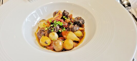 This French dish, made with tender snails, pearl onions, mushrooms and tomatoes in a rich sauce, is served at a restaurant in Paris.