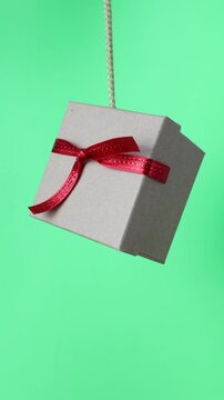 Christmas decorations gift package hanging on a string and chroma key copy space