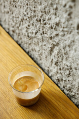 Cup of milk dirty coffee on table by the window.