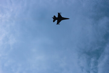 Silhouettes of fighter planes with smoke in airshow