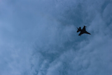 Silhouettes of fighter planes with smoke in airshow