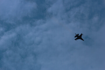 Silhouettes of fighter planes with smoke in airshow
