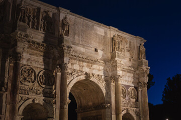Night View of Illuminated Arch of Constantine in Rome with Historic Sculptures and Reliefs Under Deep Blue Sky