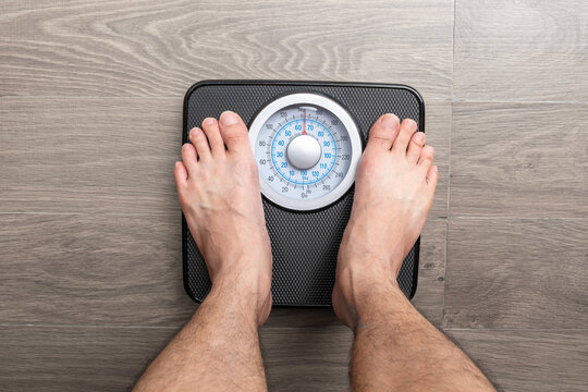 Legs of women standing on scales weight. Concept of health and weight loss.