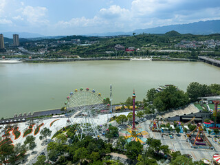 Aerial view of Jialing River in Guanyuan with amusement park on foreground, Sichuan, China. 