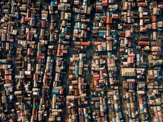 Aerial view of a dense settlement of colorful buildings and narrow waterways creates an intricate tapestry of urban life., Lagos, Lagos, Nigeria.