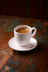 Cup of coffee on rustic wooden background. Soft focus. Copy space	