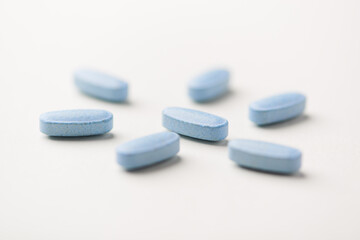 Multivitamin tablets on bright paper background. Close up. Copy space	