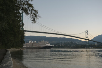 Modern classic cruiseship or cruise ship liner Nieuw Amsterdam arrival into Vancouver port, Canada during sunrise after cruise to Alaska with Stanley Park landscape