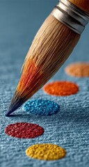 Fototapeta premium Close-up of paintbrush tip, vibrant colors on fabric