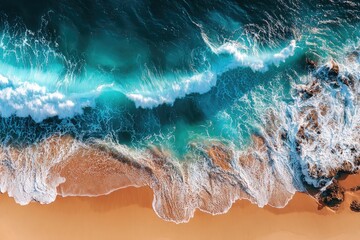 Fototapeta premium Aerial view of turquoise waves crashing on a sandy beach