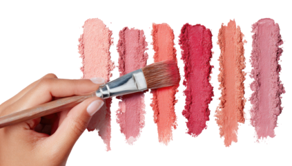 Hand with makeup brush applying various shades of blush