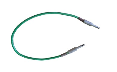 Obraz premium Green audio jack cable with metal connectors for musical instruments and sound equipment isolated on white background