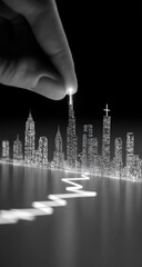 Fingertip illuminating a city skyline atop a graph