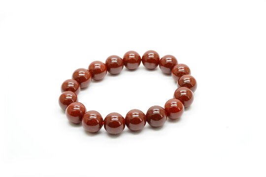 Red jadeite jade bracelet isolated on white background. Natural red brown color Burmese (Myanmar) jade type A