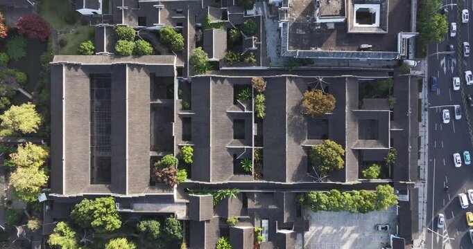Modern architectural complex viewed from above with surrounding greenery and street scene