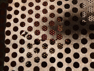 Abstract pattern of a perforated metal grid.