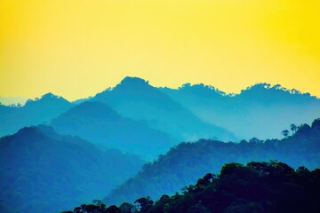 Blue-hued mountain range at sunset, hazy atmosphere