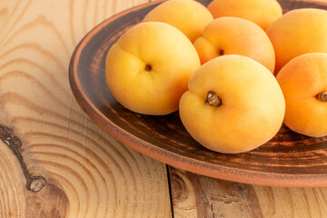 Organic ripe apricots on a wooden table, close-up