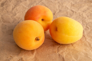 Organic ripe apricots on kraft paper, macro.