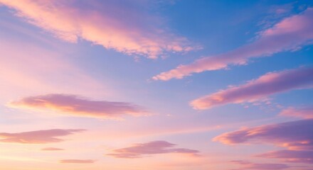 Fototapeta premium Sunset clouds painted with pink and purple hues against a blue sky