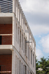 Construction site showcasing new building structure under clear blue sky during daylight hours