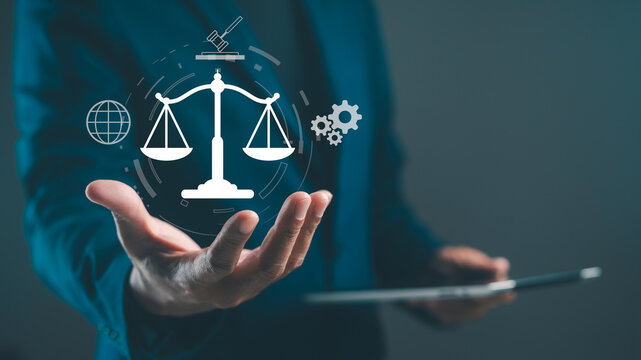 A professional individual holds a tablet, showcasing digital icons of scales, a globe, and gears, symbolizing law and technology integration.