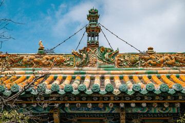 Chinese traditional taoism temple roof with tree branches, Chinese garden aesthetics