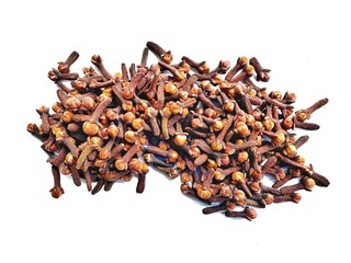 A pile of fresh dried brown cloves isolated on white background. Spice cloves. Close up of dried aromatic clove flower buds.