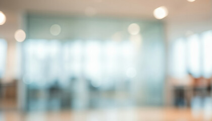 Blurred office interior with glass walls and bright lighting creates an abstract scene, evoking a modern professional workspace that feels sleek, open, and minimal.