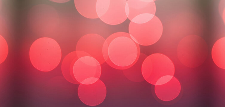 Abstract blurred background with red and pink bokeh lights, creating a glowing dreamy atmosphere that feels romantic, vibrant, and visually elegant.