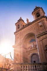 Obraz premium Facade of the parish church of Our Lady of Pompei in contrast with the bright sun rays, Marsaxlokk MALTA