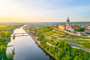 Aerial view captures Melnik City and its historic chateau perched above the serene Labe River. The...